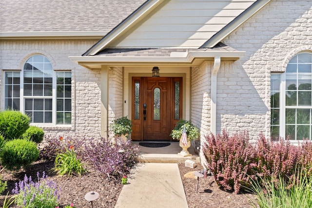 703 Amy Cir, Marble Falls, TX 78654 - entrance to property with a shingled roof and brick siding