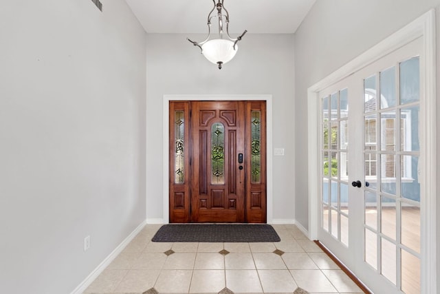 703 Amy Cir, Marble Falls, TX 78654 - foyer with light tile patterned flooring, a towering ceiling, and french doors