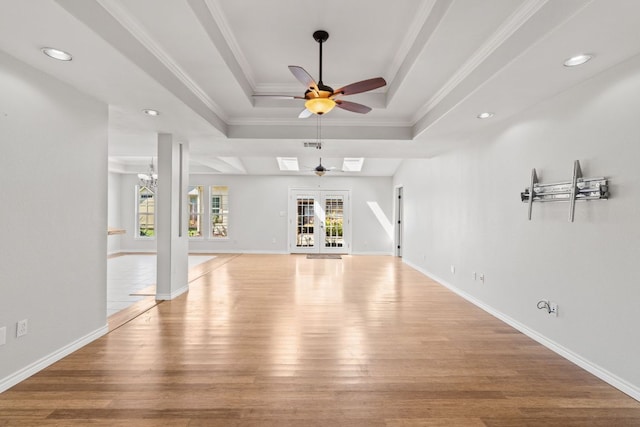 703 Amy Cir, Marble Falls, TX 78654 - unfurnished living room with a raised ceiling, ceiling fan, light wood-style floors, crown molding, and recessed lighting