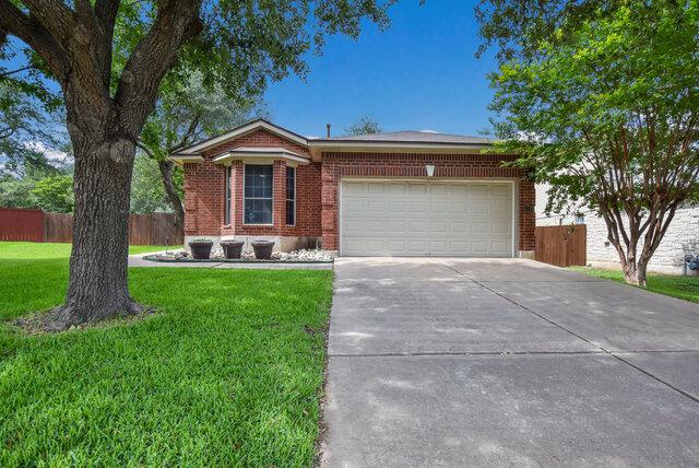 1119 Brinkley Dr, Cedar Park, TX 78613 - view of front of home with brick siding, an attached garage, and concrete driveway