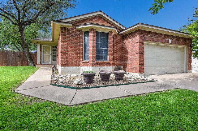 1119 Brinkley Dr, Cedar Park, TX 78613 - view of front of property with brick siding, a garage, and driveway