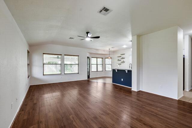 1119 Brinkley Dr, Cedar Park, TX 78613 - unfurnished living room featuring ceiling fan, dark wood-type flooring, and lofted ceiling
