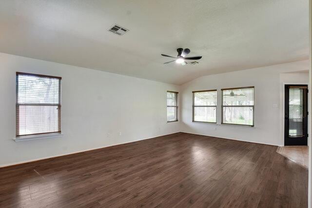 1119 Brinkley Dr, Cedar Park, TX 78613 - spare room with dark wood-style floors, ceiling fan, and vaulted ceiling
