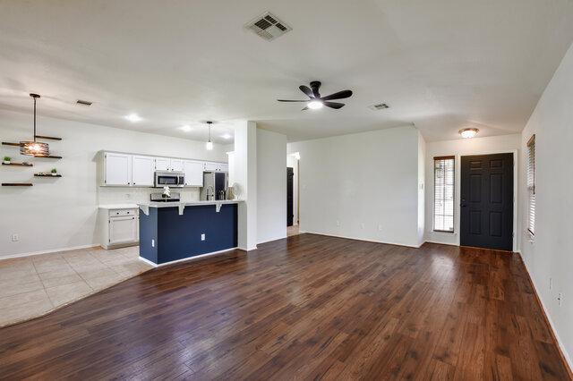 1119 Brinkley Dr, Cedar Park, TX 78613 - unfurnished living room with ceiling fan and wood finished floors