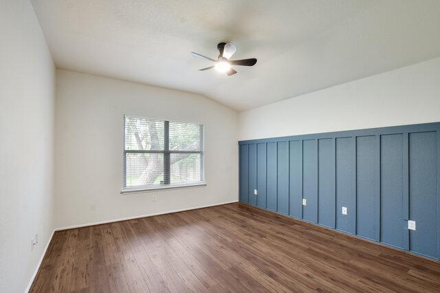1119 Brinkley Dr, Cedar Park, TX 78613 - spare room featuring wood finished floors, a ceiling fan, and lofted ceiling