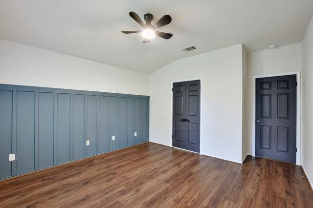 1119 Brinkley Dr, Cedar Park, TX 78613 - unfurnished bedroom featuring vaulted ceiling, dark wood finished floors, and ceiling fan