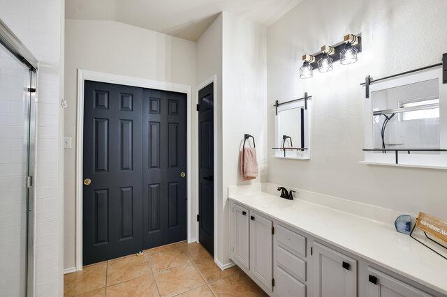 1119 Brinkley Dr, Cedar Park, TX 78613 - full bath with vanity, tile patterned flooring, and a tile shower