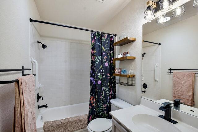 1119 Brinkley Dr, Cedar Park, TX 78613 - full bath with shower / bath combo with shower curtain, vanity, and a textured wall