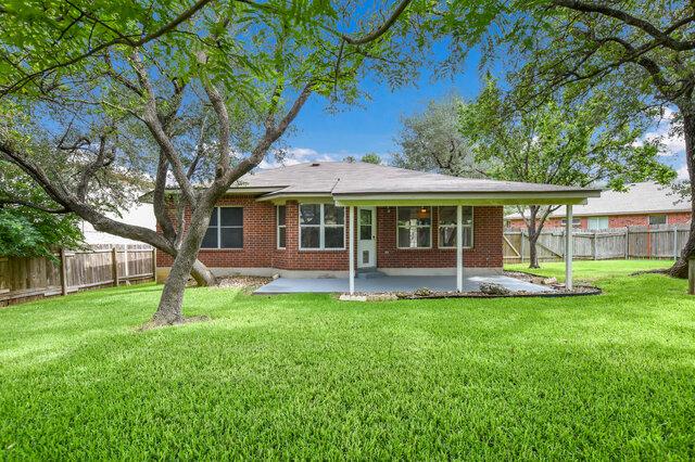1119 Brinkley Dr, Cedar Park, TX 78613 - rear view of house with a patio, a fenced backyard, and brick siding