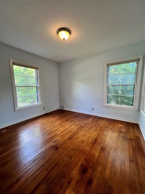 1511 Romeria Dr, Austin, TX 78757 - empty room with dark wood finished floors and baseboards