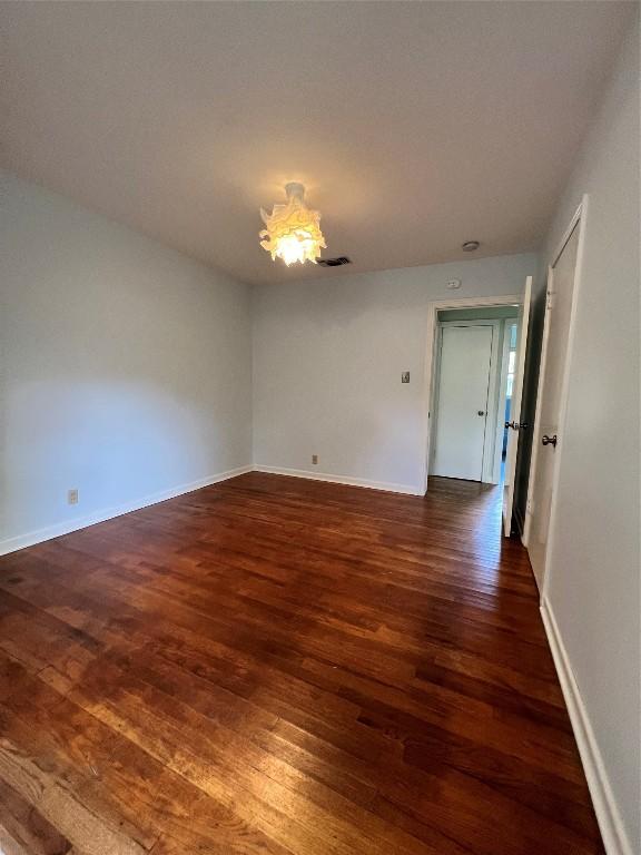 1511 Romeria Dr, Austin, TX 78757 - empty room featuring dark wood finished floors and baseboards