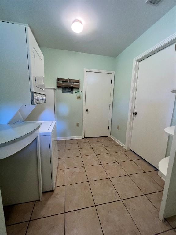1511 Romeria Dr, Austin, TX 78757 - washroom featuring stacked washer / drying machine and light tile patterned flooring