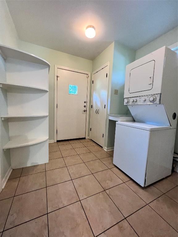 1511 Romeria Dr, Austin, TX 78757 - washroom featuring stacked washing machine and dryer and light tile patterned floors