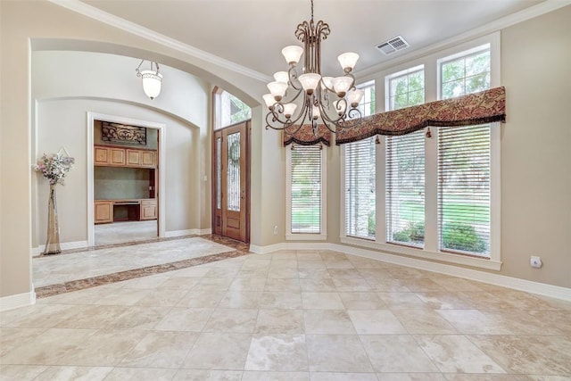 25 Meadows End Dr, Georgetown, TX 78628 - entryway featuring crown molding, a chandelier, and arched walkways