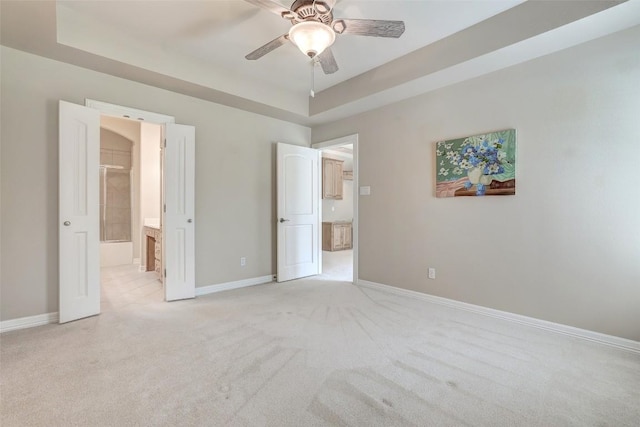 25 Meadows End Dr, Georgetown, TX 78628 - unfurnished bedroom with light carpet, ceiling fan, and a tray ceiling