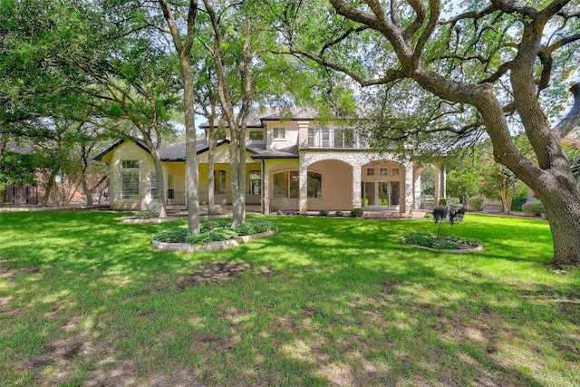 25 Meadows End Dr, Georgetown, TX 78628 - back of property with a lawn and stucco siding
