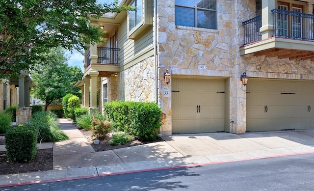 14815 Avery Ranch Blvd Unit 3301, Austin, TX 78717 - entrance to property with stone siding, a balcony, an attached garage, and driveway