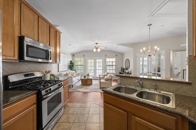 14815 Avery Ranch Blvd Unit 3301, Austin, TX 78717 - kitchen with appliances with stainless steel finishes, brown cabinetry, tasteful backsplash, a chandelier, and open floor plan