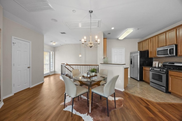14815 Avery Ranch Blvd Unit 3301, Austin, TX 78717 - dining area featuring wood finished floors, attic access, and a chandelier