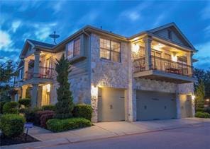 14815 Avery Ranch Blvd Unit 3301, Austin, TX 78717 - view of front facade with stone siding, an attached garage, a balcony, and concrete driveway