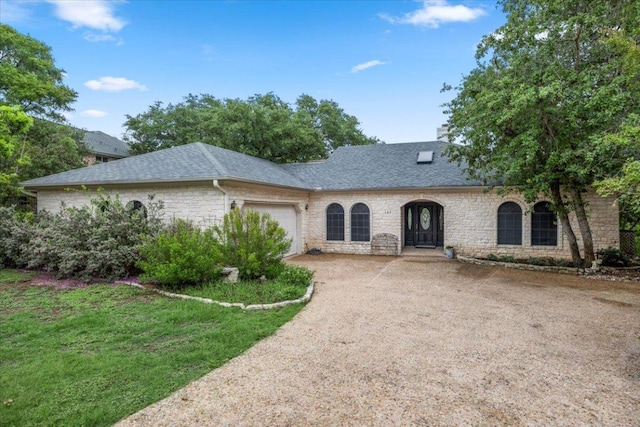 124 Hurst Creek Rd, Austin, TX 78734 - french provincial home with a garage, driveway, roof with shingles, and stone siding