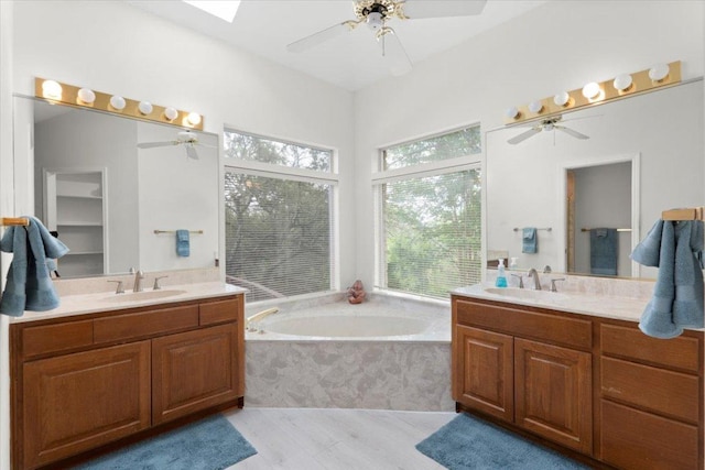124 Hurst Creek Rd, Austin, TX 78734 - full bathroom with two vanities, a ceiling fan, and a bath