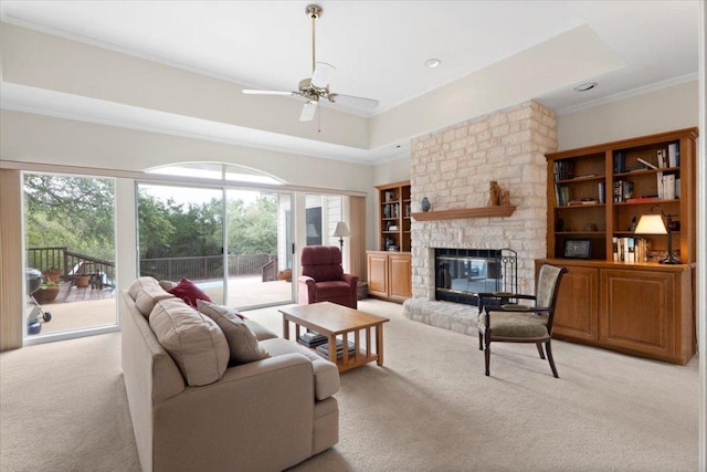 124 Hurst Creek Rd, Austin, TX 78734 - living room with light carpet, ornamental molding, ceiling fan, and a stone fireplace