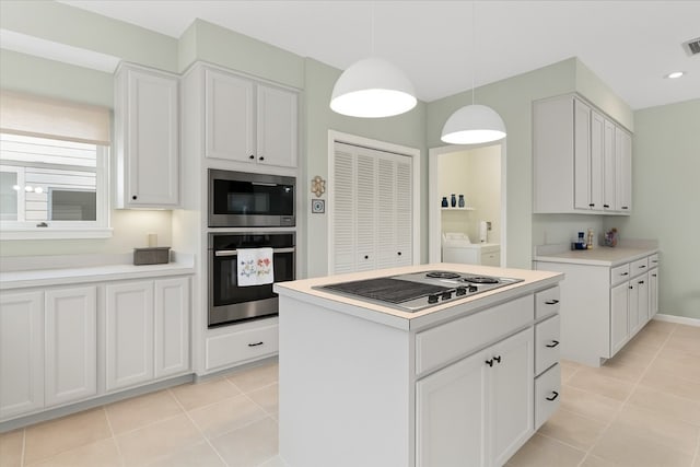 124 Hurst Creek Rd, Austin, TX 78734 - kitchen with stainless steel appliances, washer and dryer, light tile patterned floors, light countertops, and white cabinetry