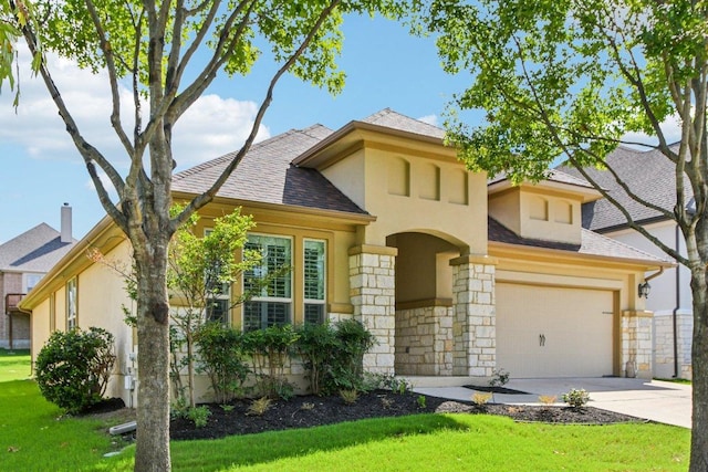 3213 Venezia Vw, Leander, TX 78641 - view of front of home with stucco siding, stone siding, a front lawn, and concrete driveway