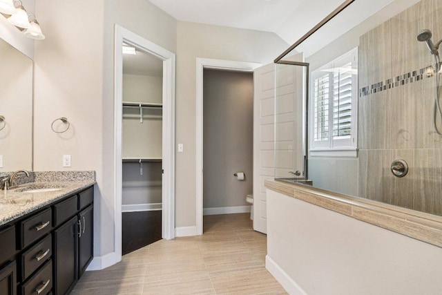 3213 Venezia Vw, Leander, TX 78641 - bathroom featuring walk in shower, vanity, a spacious closet, and tile patterned floors