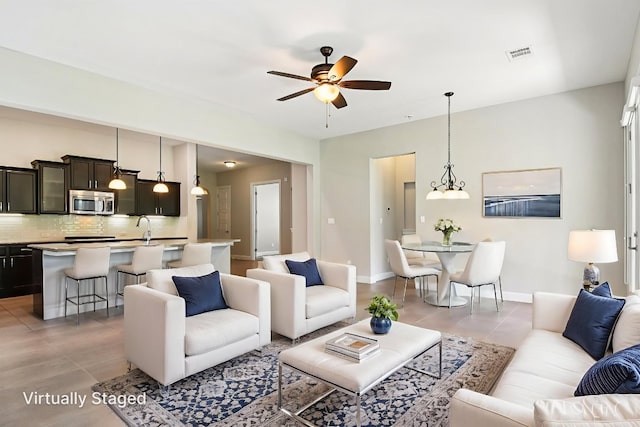3213 Venezia Vw, Leander, TX 78641 - living area with a ceiling fan and light tile patterned floors