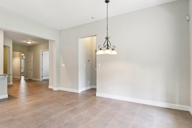 3213 Venezia Vw, Leander, TX 78641 - spare room featuring arched walkways, light tile patterned floors, and fire sprinkler in ceiling