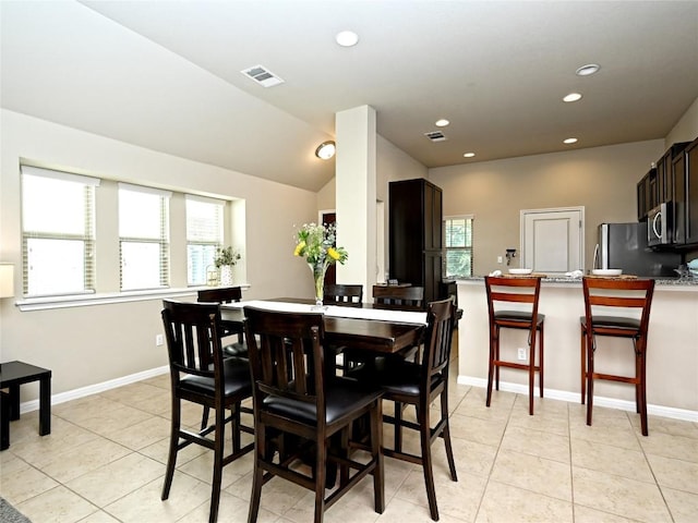 4811 Portillo Way, Pflugerville, TX 78660 - dining area featuring recessed lighting, light tile patterned floors, and vaulted ceiling