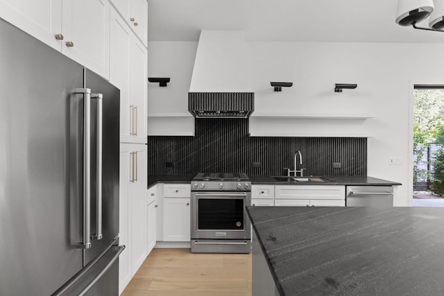 501 E 50th St, Austin, TX 78751 - kitchen with appliances with stainless steel finishes, open shelves, decorative backsplash, white cabinetry, and light wood-type flooring