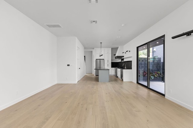 501 E 50th St, Austin, TX 78751 - unfurnished living room with light wood-type flooring and baseboards