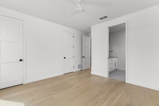 501 E 50th St, Austin, TX 78751 - unfurnished bedroom featuring light wood-type flooring, connected bathroom, and a ceiling fan