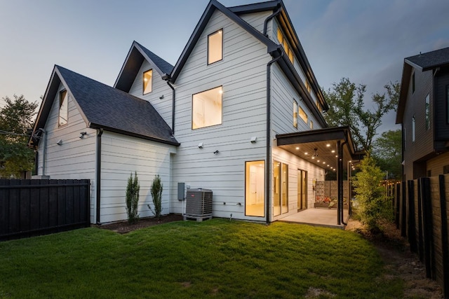 501 E 50th St, Austin, TX 78751 - back of house featuring a fenced backyard, a patio, and a shingled roof