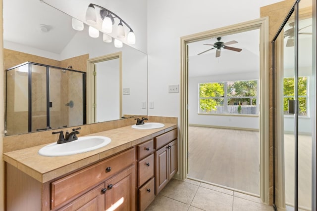 325 Swenson Dr, Hutto, TX 78634 - bathroom featuring lofted ceiling, ceiling fan, double vanity, a stall shower, and tile patterned flooring