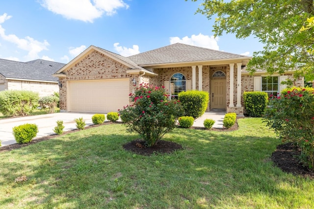 325 Swenson Dr, Hutto, TX 78634 - view of front facade featuring an attached garage, a front lawn, brick siding, and driveway