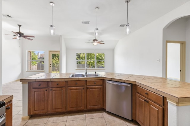 325 Swenson Dr, Hutto, TX 78634 - kitchen with dishwasher, a ceiling fan, arched walkways, and brown cabinets