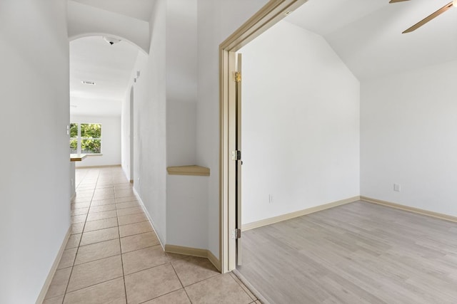 325 Swenson Dr, Hutto, TX 78634 - hallway featuring arched walkways, vaulted ceiling, and light tile patterned floors