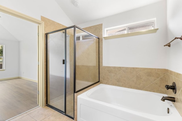 325 Swenson Dr, Hutto, TX 78634 - bathroom with plenty of natural light, a bath, a stall shower, and lofted ceiling