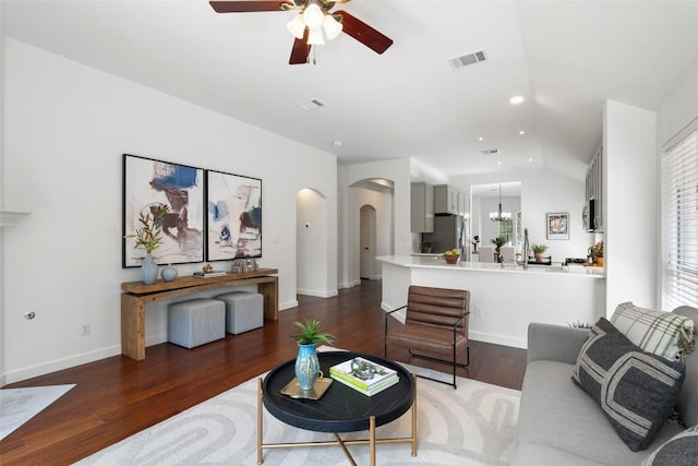 4608 Hibiscus Valley Dr, Austin, TX 78739 - living area with arched walkways, ceiling fan, wood finished floors, a chandelier, and vaulted ceiling