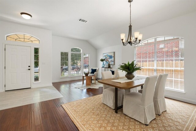 4608 Hibiscus Valley Dr, Austin, TX 78739 - dining room featuring a chandelier, wood finished floors, and vaulted ceiling
