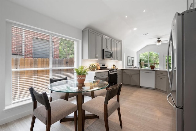 4608 Hibiscus Valley Dr, Austin, TX 78739 - kitchen featuring appliances with stainless steel finishes, gray cabinetry, vaulted ceiling, a ceiling fan, and light wood finished floors