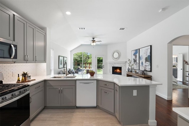 4608 Hibiscus Valley Dr, Austin, TX 78739 - kitchen featuring appliances with stainless steel finishes, gray cabinetry, ceiling fan, open floor plan, and vaulted ceiling