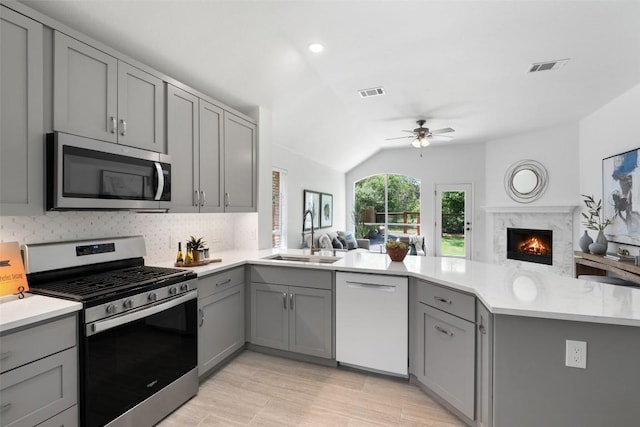 4608 Hibiscus Valley Dr, Austin, TX 78739 - kitchen featuring stainless steel appliances, gray cabinetry, open floor plan, lofted ceiling, and recessed lighting