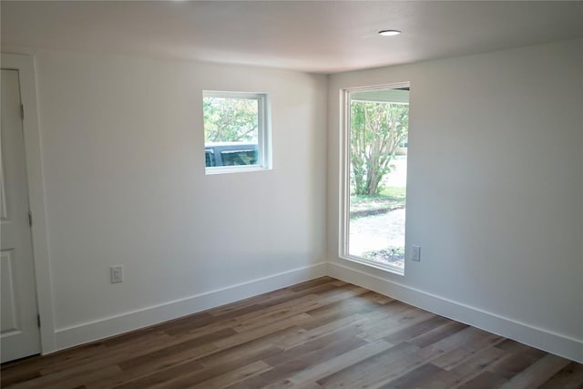 545 W Vaughan St, Bertram, TX 78605 - unfurnished room featuring healthy amount of natural light and wood finished floors