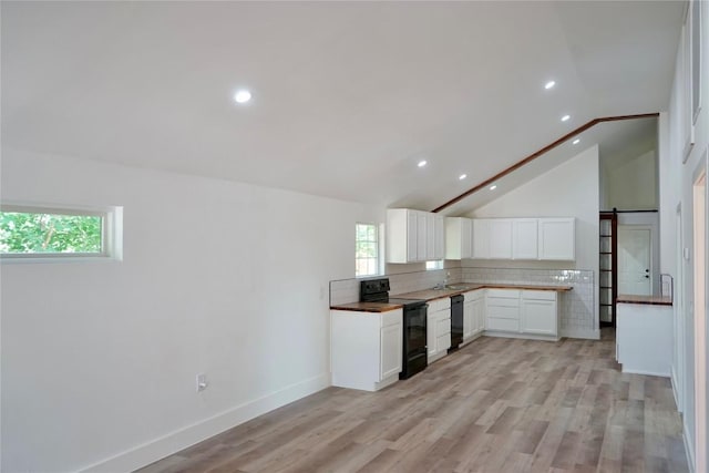 545 W Vaughan St, Bertram, TX 78605 - kitchen with black appliances, recessed lighting, white cabinetry, backsplash, and vaulted ceiling