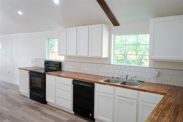 545 W Vaughan St, Bertram, TX 78605 - kitchen with butcher block counters, black appliances, tasteful backsplash, light wood-type flooring, and recessed lighting